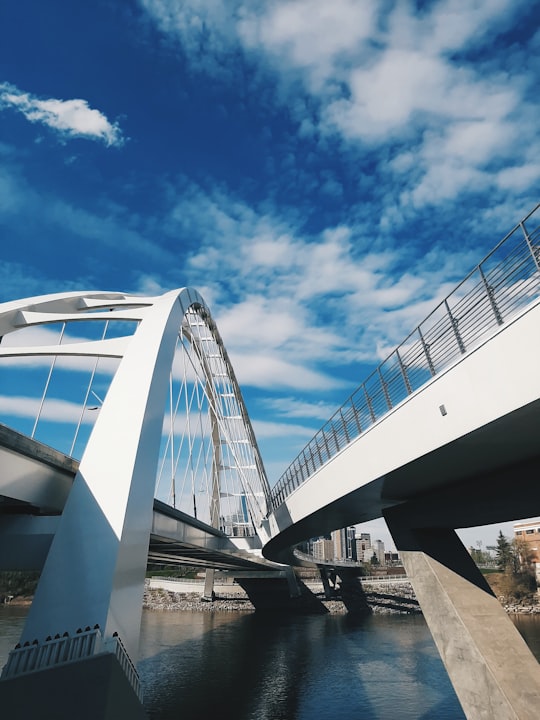 white bridge under blue sky in Edmonton Canada