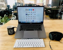 A friendly office desk with a laptop, headset, and a coffee cup, ready to assist customers.