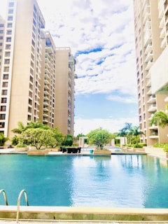 Swimming pool area surrounded by modern apartment buildings