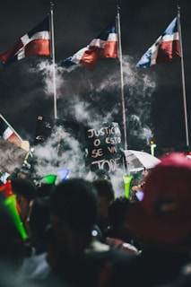 A group of passionate Colombian expatriates holding flags and banners supporting Abelardo de la Espriella during a voting event abroad.