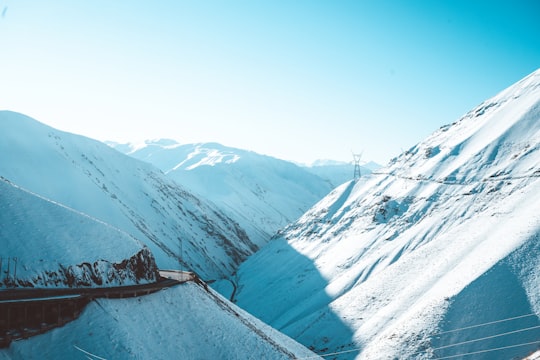 snow covered mountains during daytime in Chaloos Iran