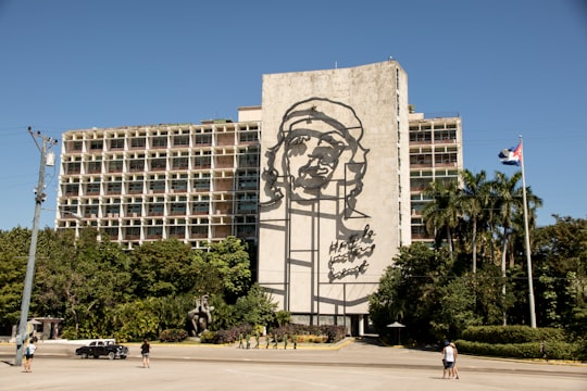 people walking near brown concrete building during daytime in Plaza de la Revolución Cuba