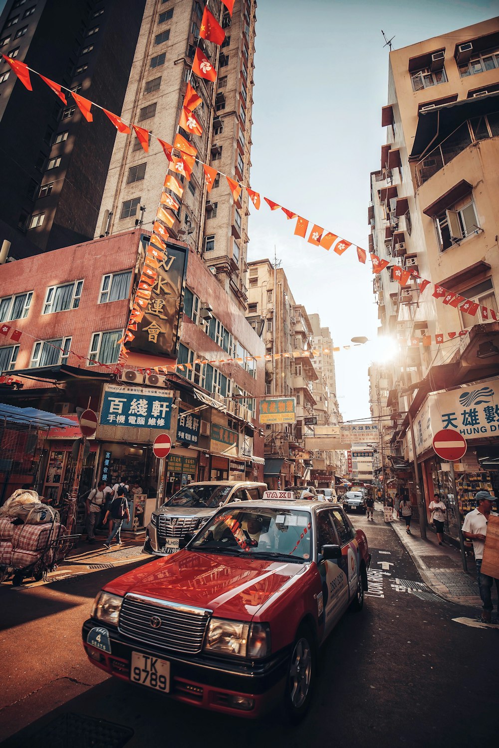 cars on road between buildings during daytime