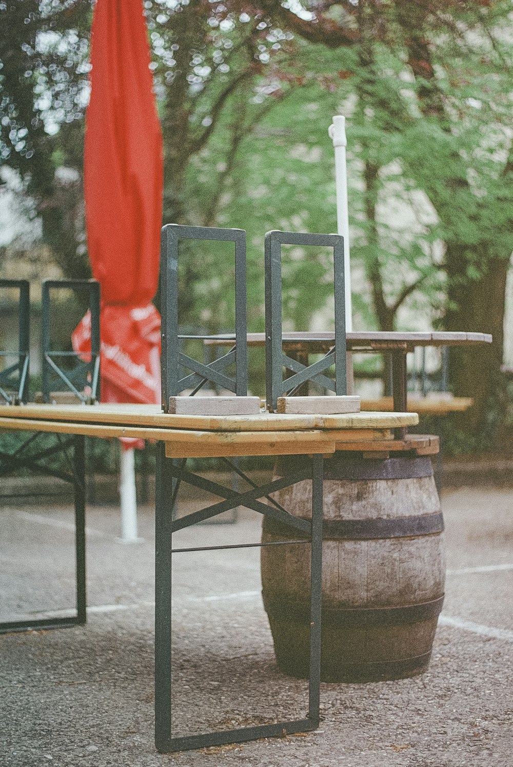 brown wooden table with green and red chairs