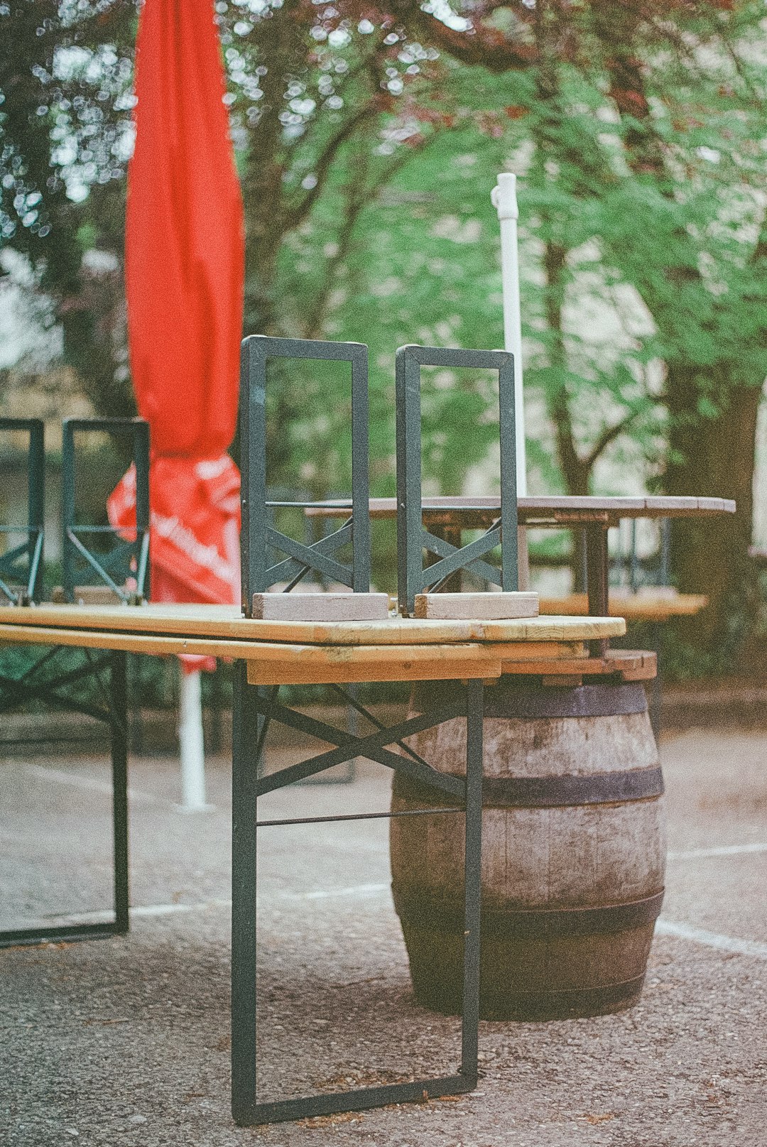 brown wooden table with green and red chairs