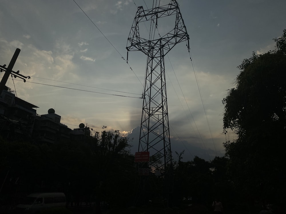 silhouette of electric tower during sunset