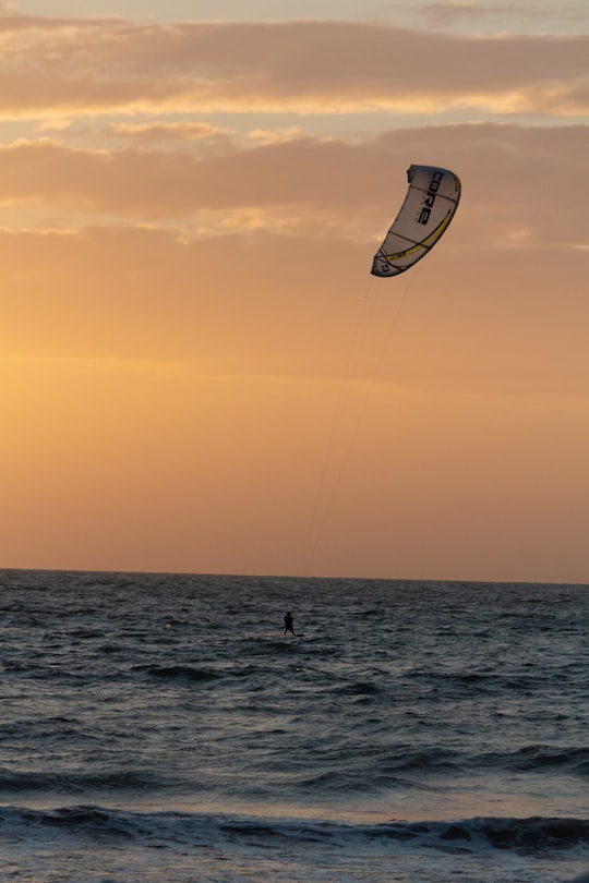 white and black kite surfing on sea during sunset in Goa India