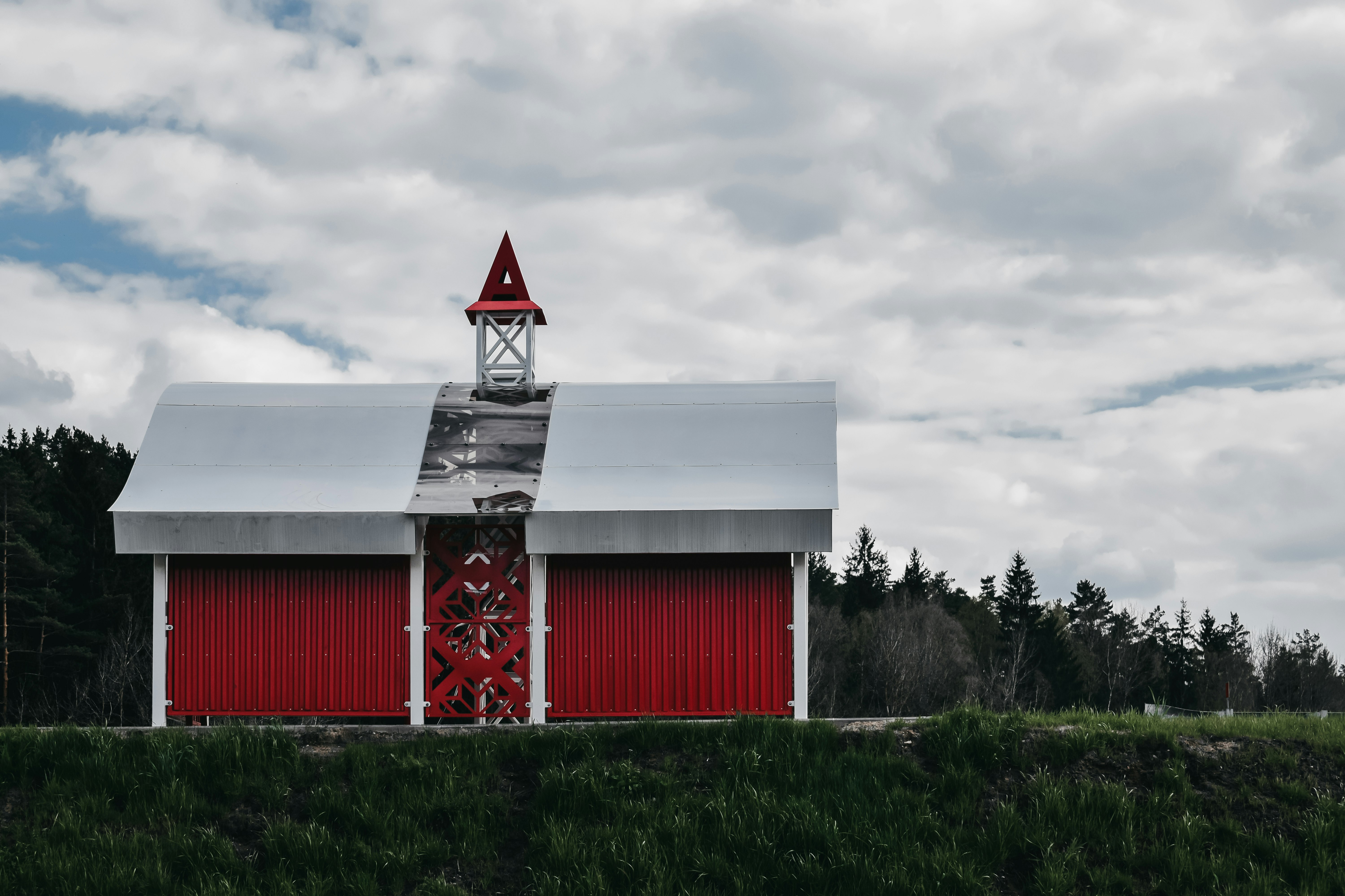 red and white barn house under cloudy sky during daytime