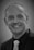 man in black suit smiling