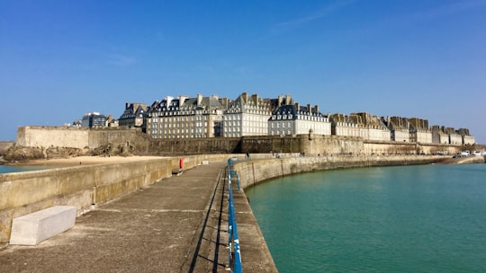 white concrete building near body of water during daytime in Saint-Malo France