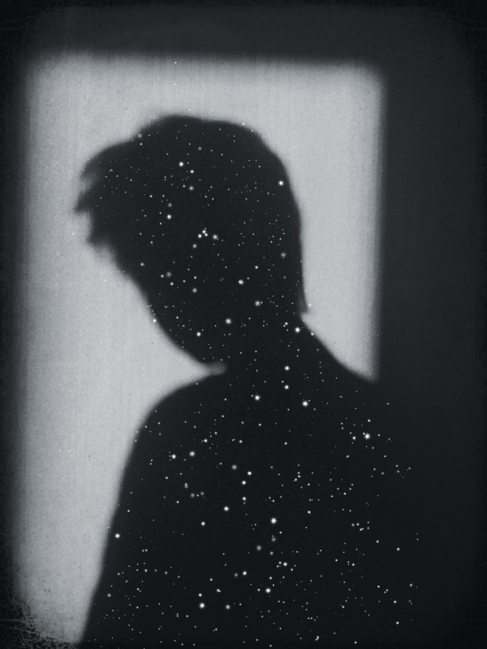 silhouette of person in front of white wall