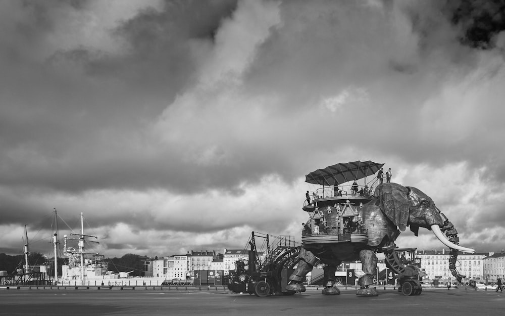 grayscale photo of people riding on horse carriage