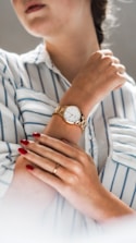 person wearing silver and gold analog watch