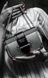 black leather handbag on white textile