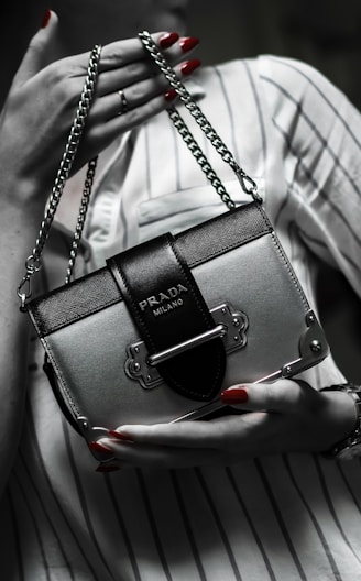 black leather handbag on white textile