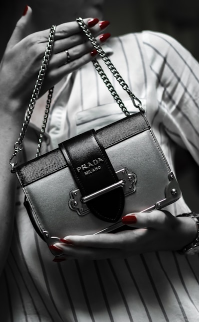 black leather handbag on white textile