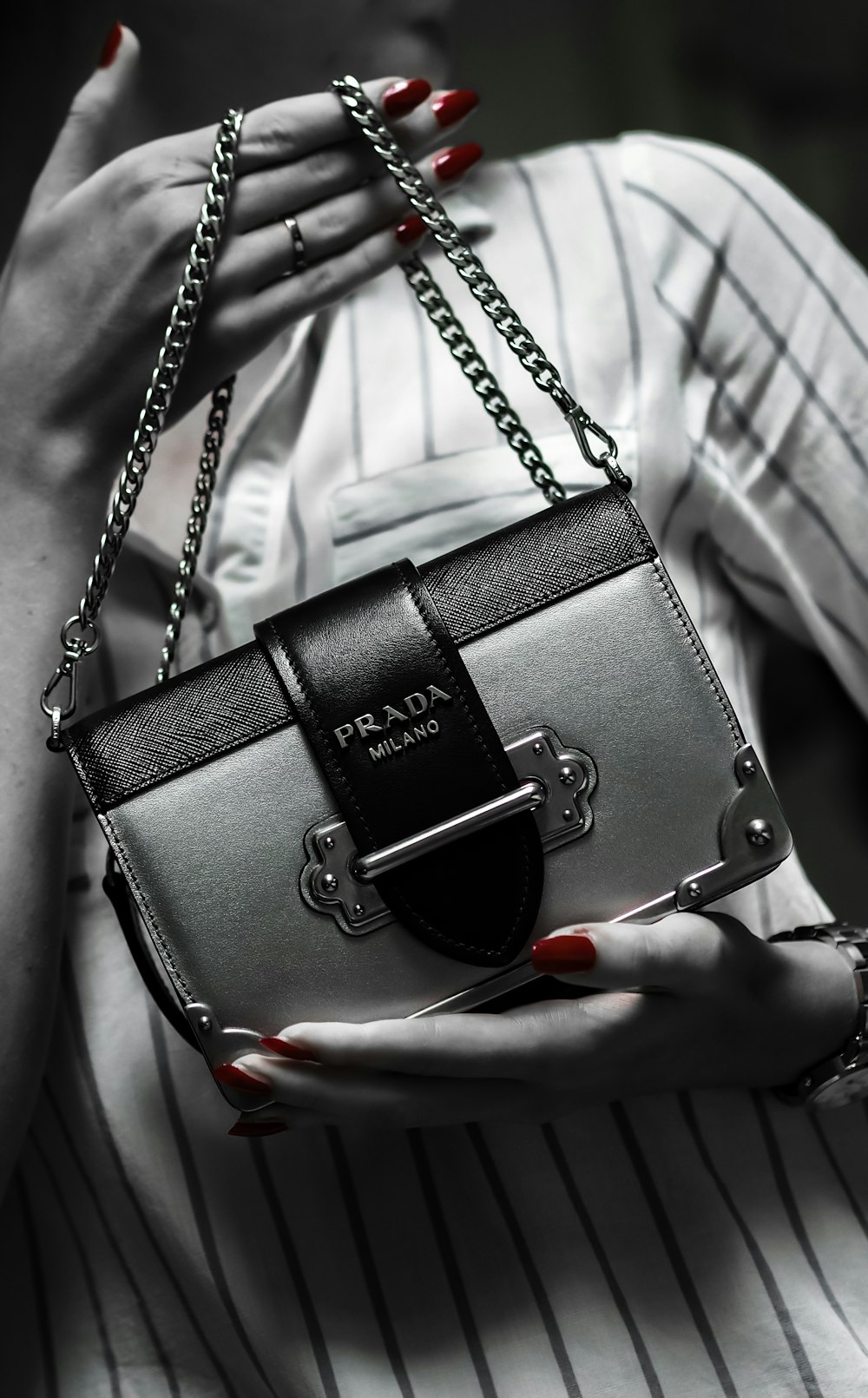 black leather handbag on white textile