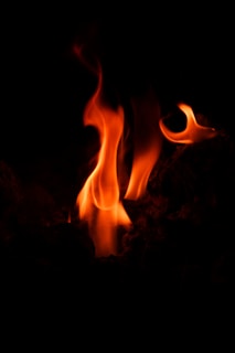 Animated firewall represented by flickering orange and red flames over a grid of data nodes.