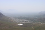 Wide aerial panorama of Serra da Mantiqueira with scattered farms and valleys.