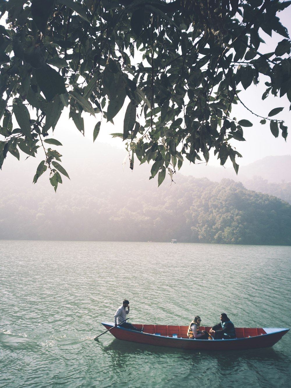 2 people riding on boat on lake during daytime