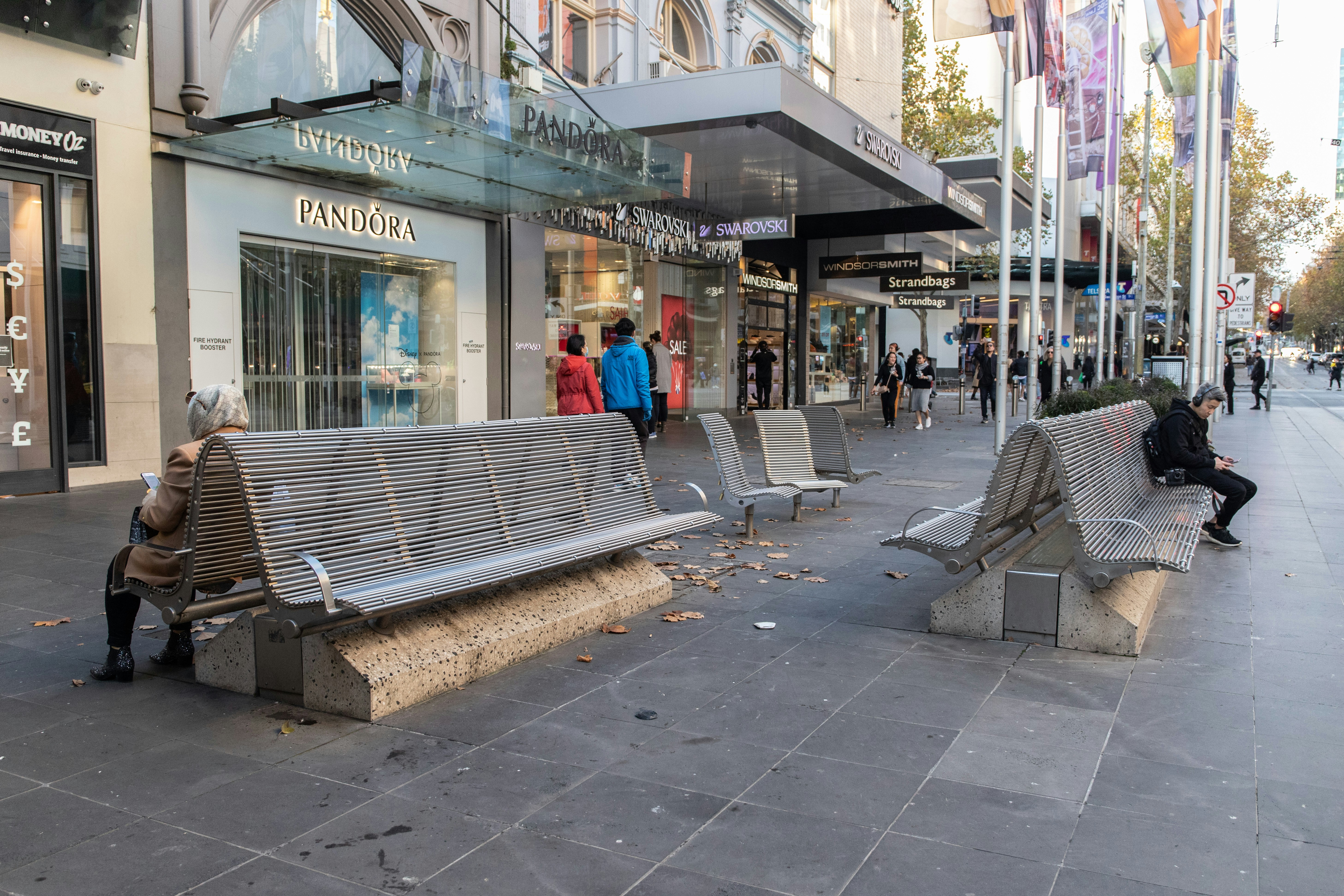 people sitting on bench near building during daytime
