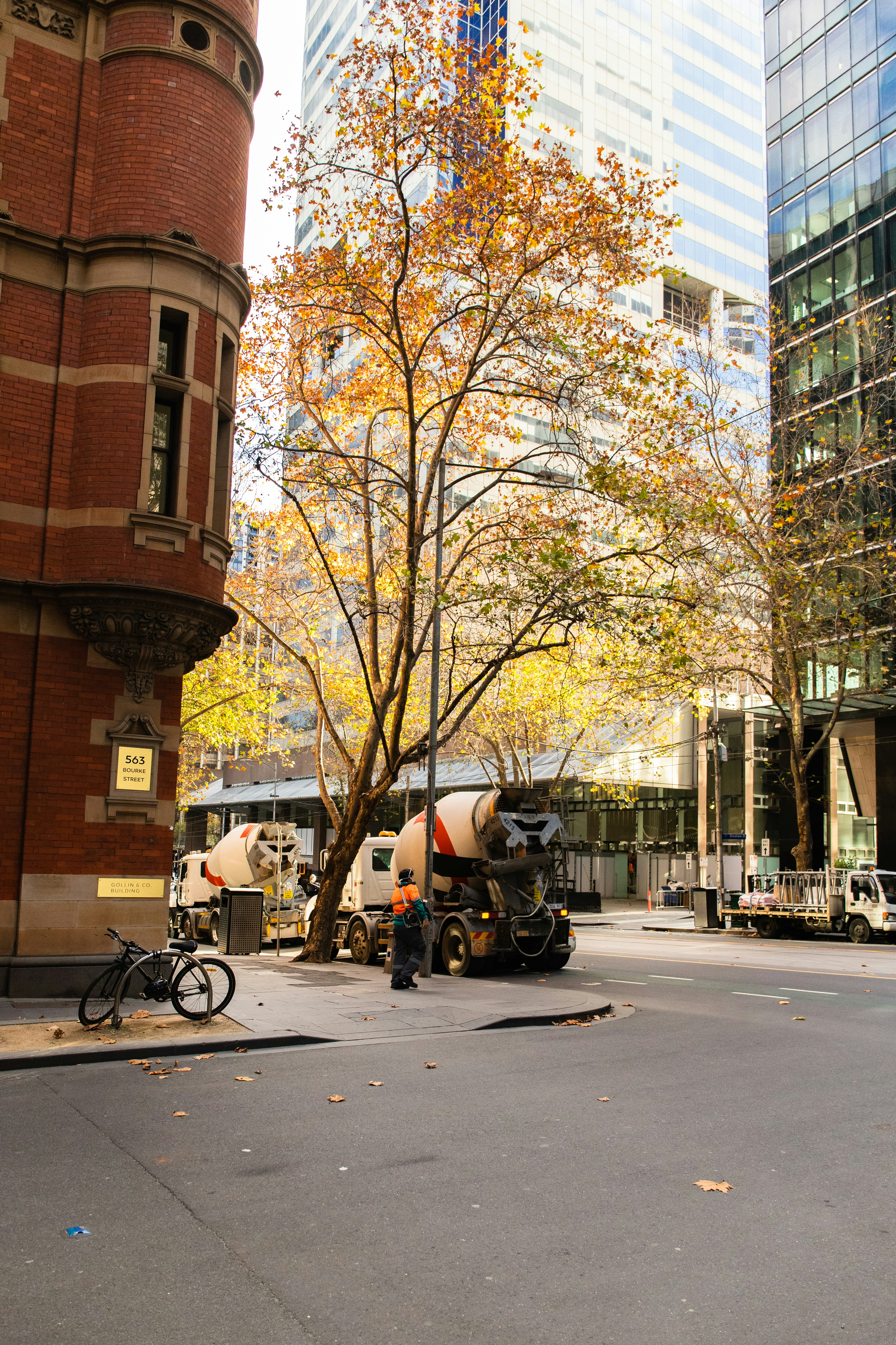 people riding bicycles on road near brown concrete building during daytime