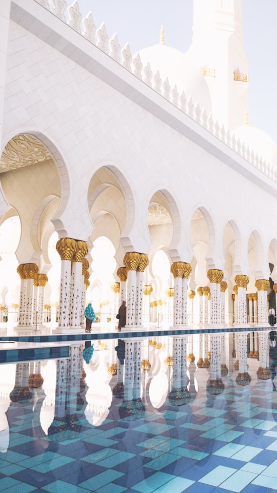 white concrete building with white metal fence in Sheikh Zayed Grand Mosque Center United Arab Emirates