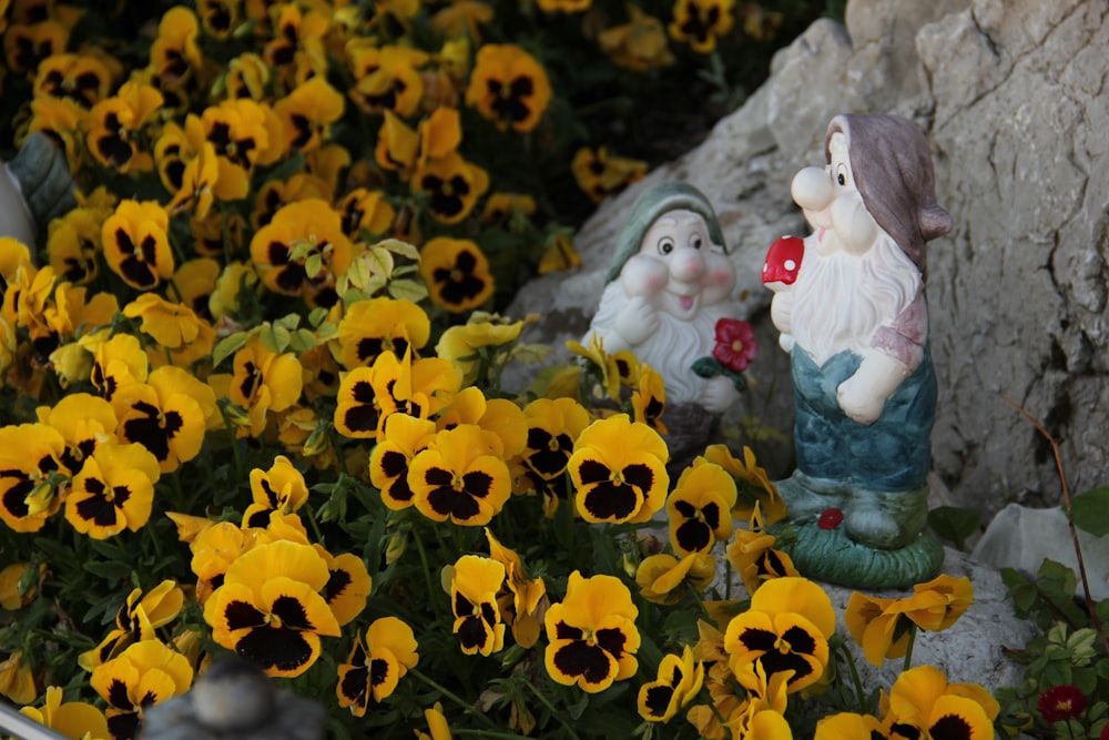 girl in white dress sitting on yellow flower field during daytime