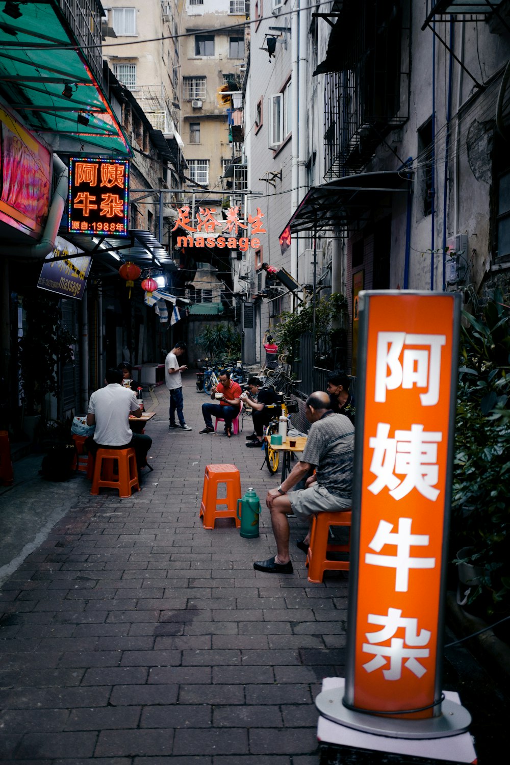 people sitting on bench near building during daytime