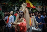 people in traditional dress standing on street during daytime