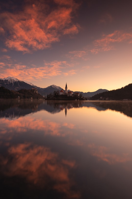body of water near mountain during daytime in Lake Bled Slovenia