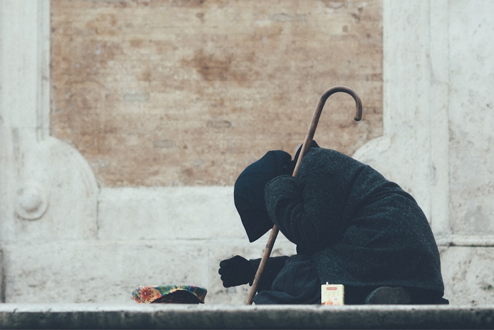 person in black jacket sitting on floor