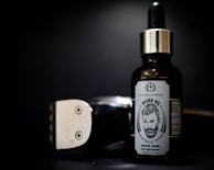 Close-up of a male influencer showcasing a premium beard oil with a confident smile.