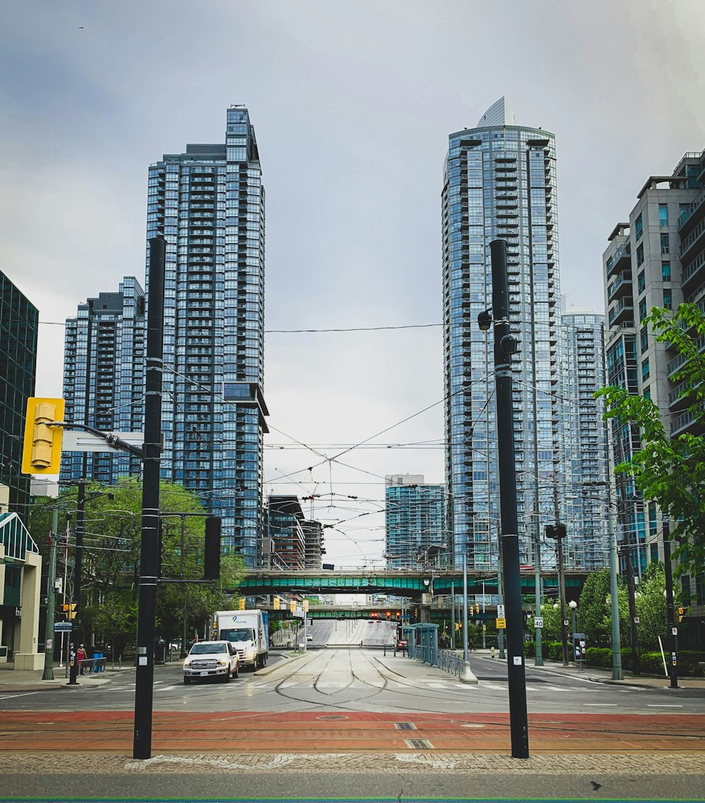 cars on road near high rise buildings during daytime