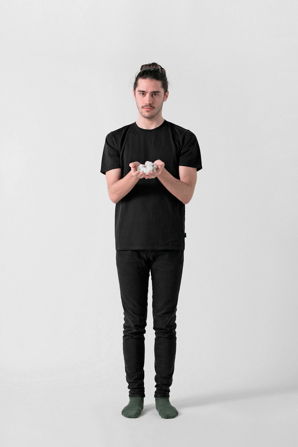 man in black crew neck t-shirt and black pants