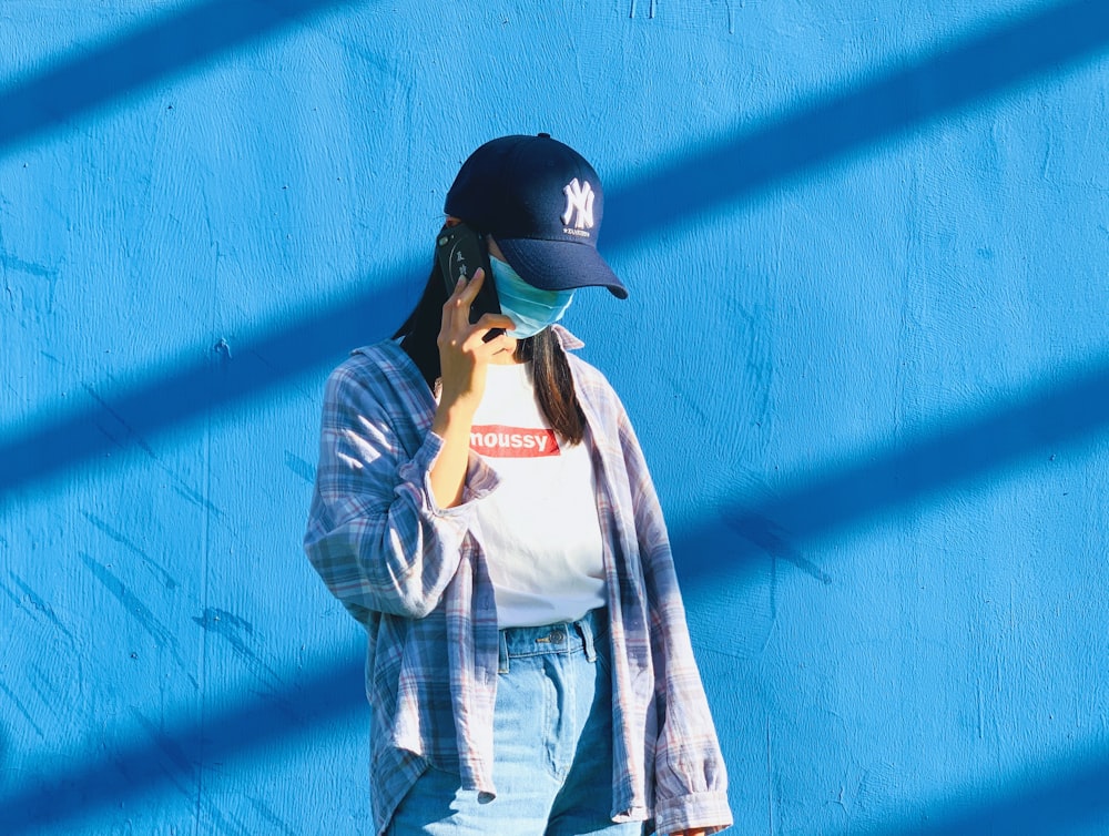 man in blue denim jacket wearing black cap