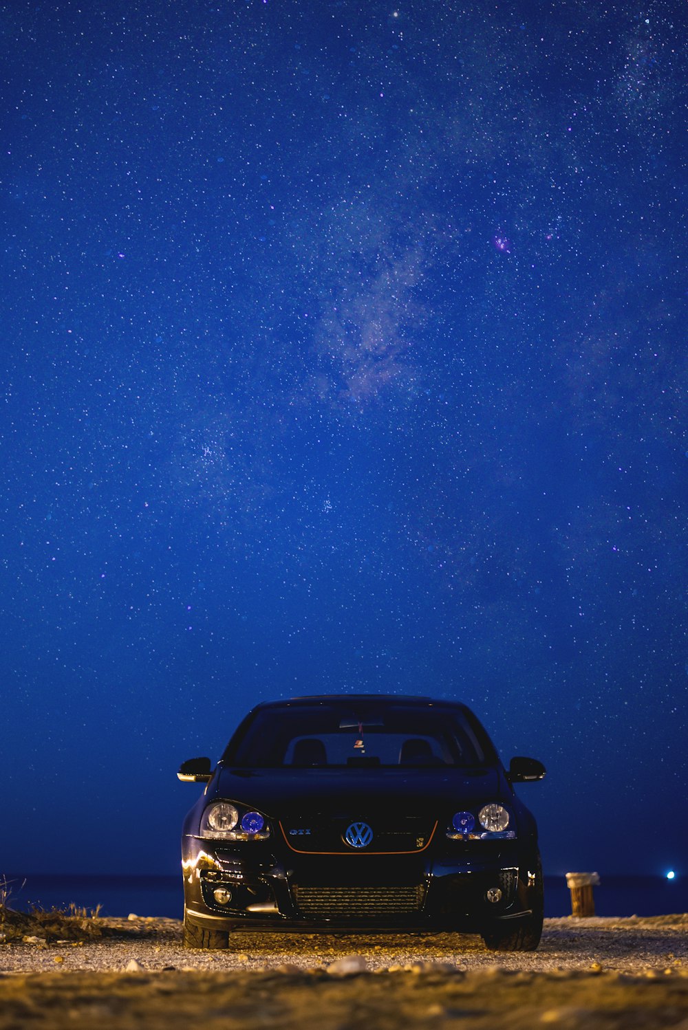 black car under starry night