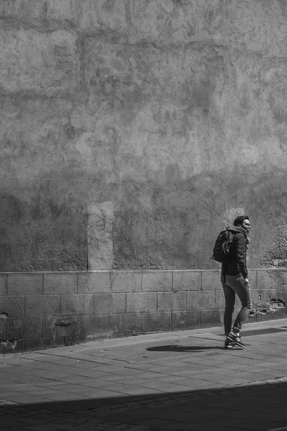 man in black jacket and pants standing on road