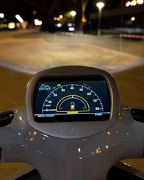 Close-up of the Rydo EV Scooty’s digital dashboard glowing softly in twilight.
