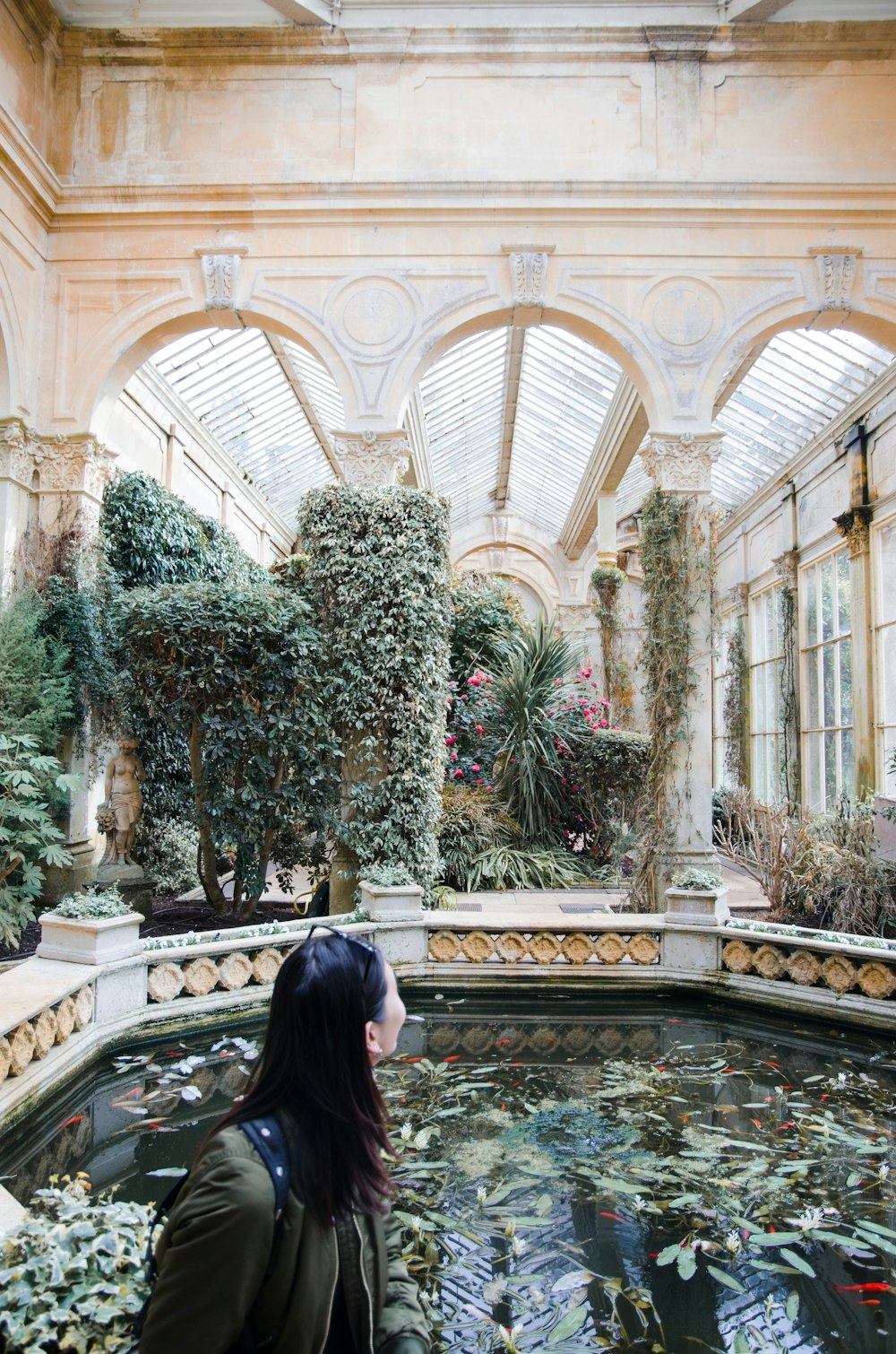 woman in black shirt standing near green plant