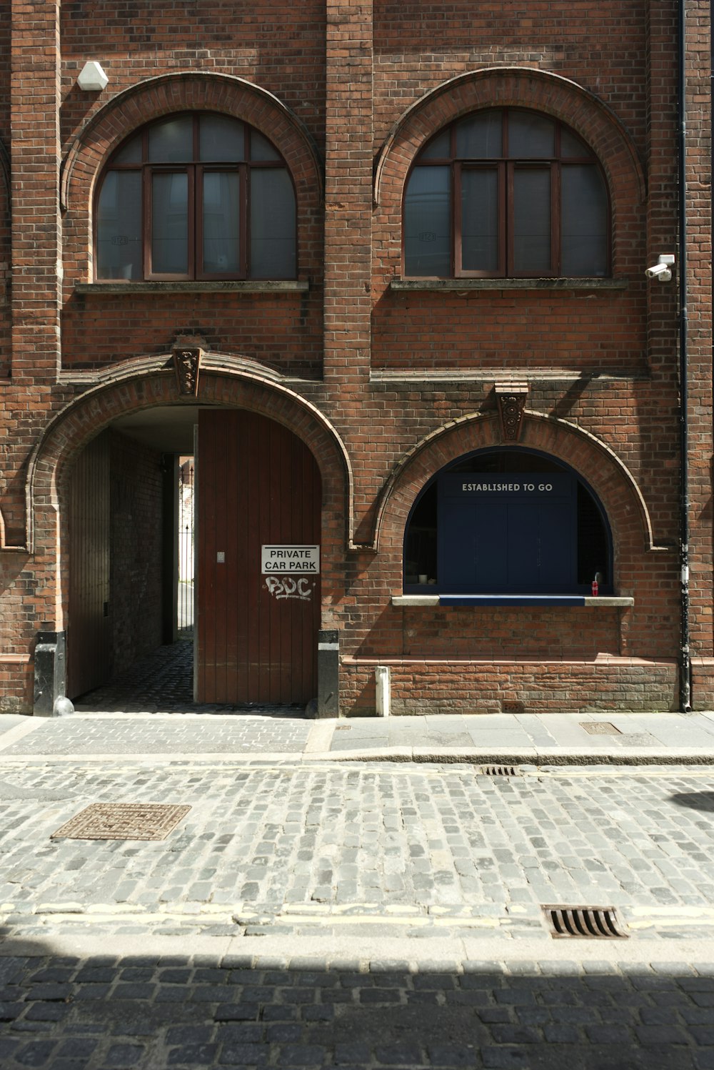 brown brick building with brown wooden door