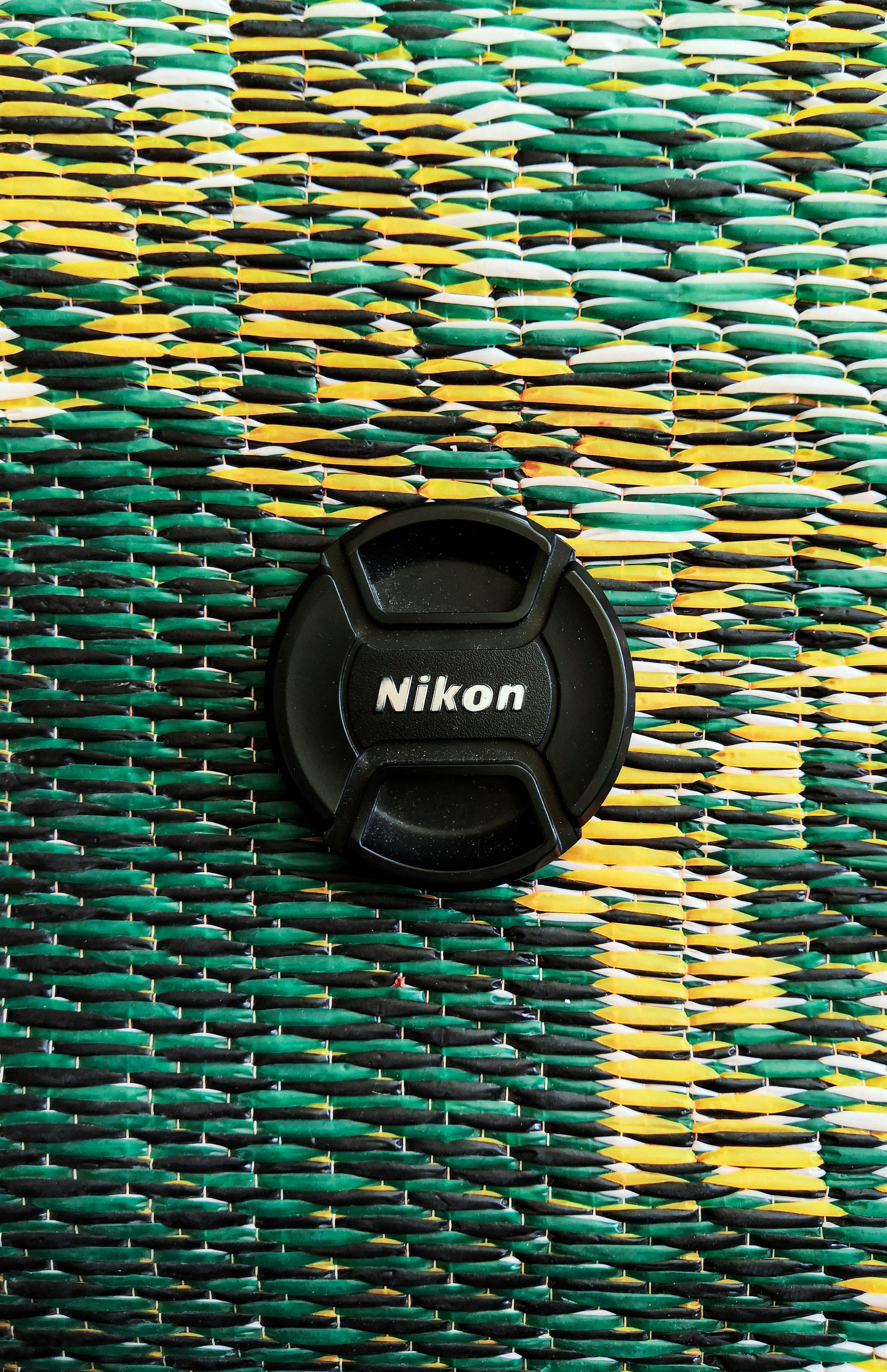 black nikon camera lens cover