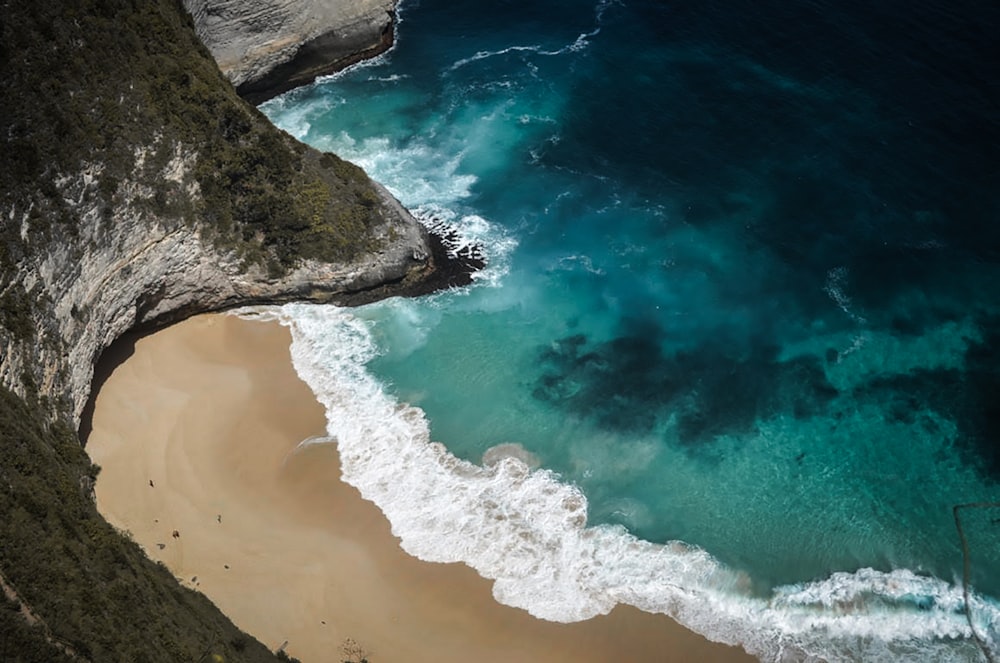 brown sand beach with brown rock formation