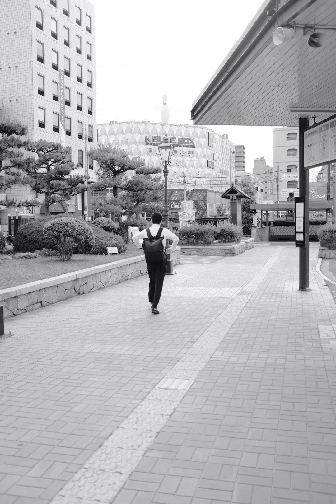 man and woman walking on sidewalk during daytime