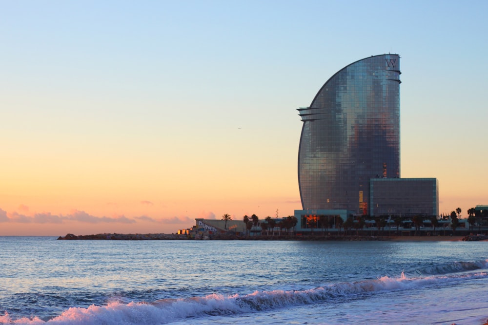 glass building near sea during sunset