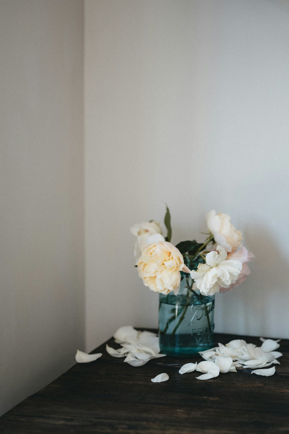 white and yellow flowers in clear glass vase