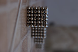silver beads on brown wooden table