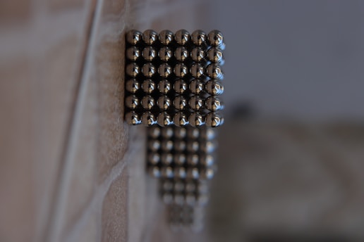 silver beads on brown wooden table