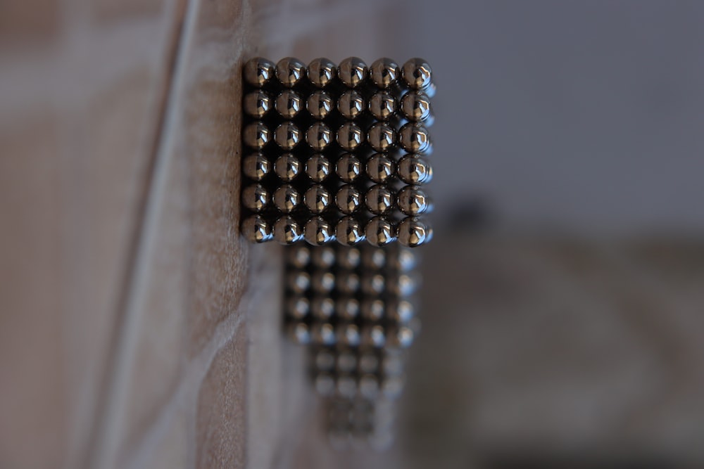 silver beads on brown wooden table