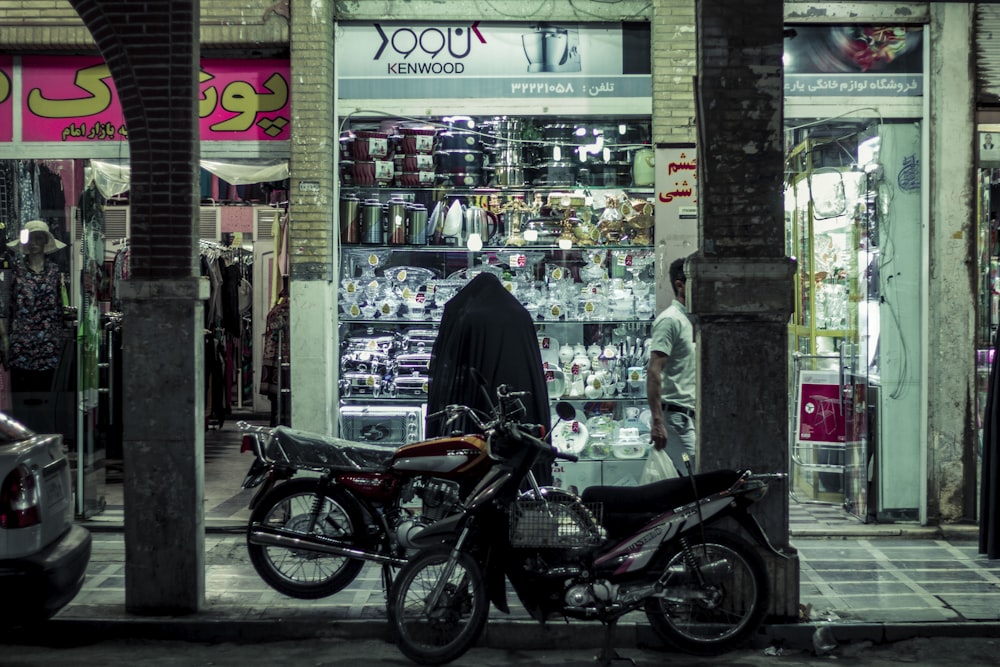 black bicycle parked beside store